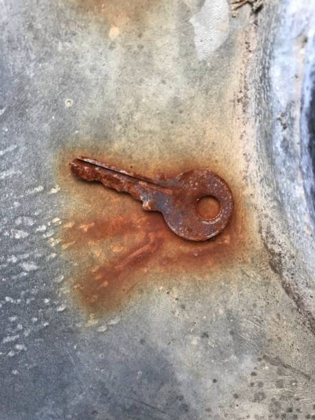 istock Picture of a rusty key lying on the concrete floor. 1334969233