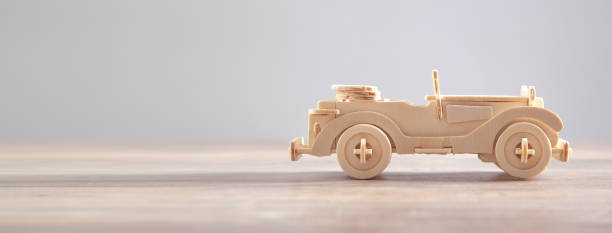 istock Old wooden retro toy car on the table. 1334972415