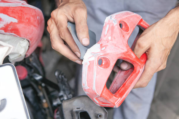 istock Preparation for painting a motorcycle. Hand in a sandpaper 1334972423