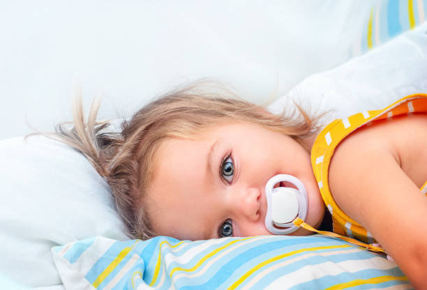 Little blue eyed boy with pacifier in his mouth.  To see more of this model: