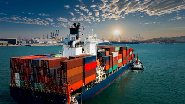 istock Aerial view container cargo ship carrying commercial container in import export business commerce logistic and transportation of international by container ship at morning over the sunlight international shipping port background 1334975225