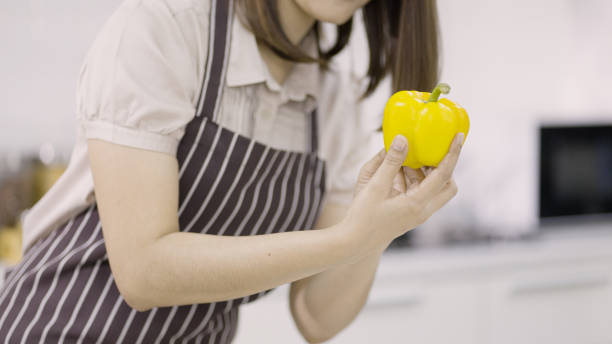 istock Woman touching fresh bell pepper 1334975389