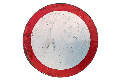 Old scratched round red road sign 'No entry' isolated on white.