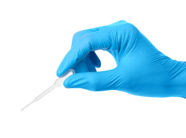istock Scientist wears blue rubber gloves hands holding transparent plastic laboratory pipette or dropper isolate on white background with clipping path 1334976622