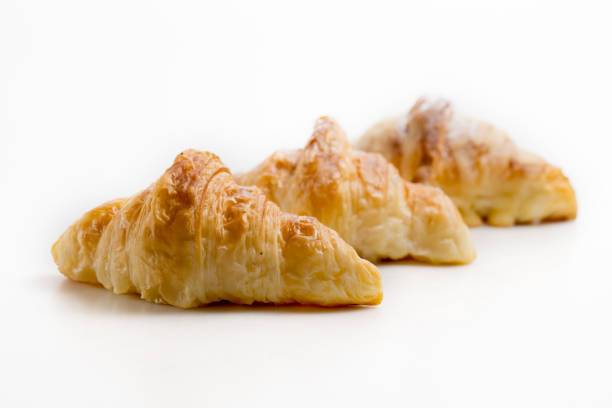 istock Croissants isolated on white background, selective focus. 1334981411