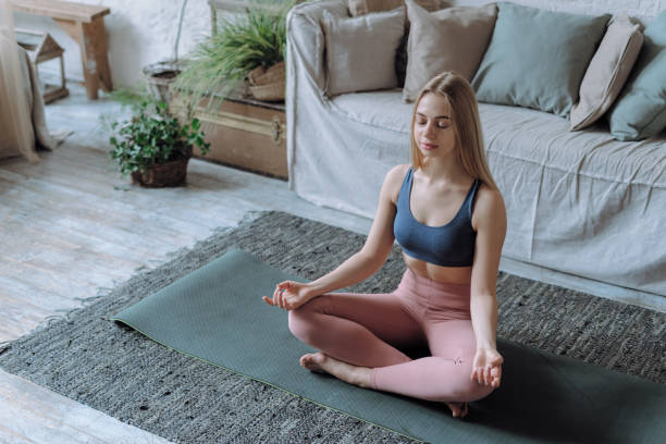 istock Young peaceful happy woman practicing meditation 1334981461