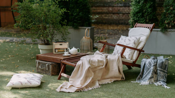 Outdoor garden wooden furniture at autumn nature, green grass. Outdoor garden wooden furniture at autumn nature, green grass. Nobody at home backyard with chair, lounge. Relax at outside terrace with blankets, pillows at retro, vintage decoration. chaise longue stock pictures, royalty-free photos & images