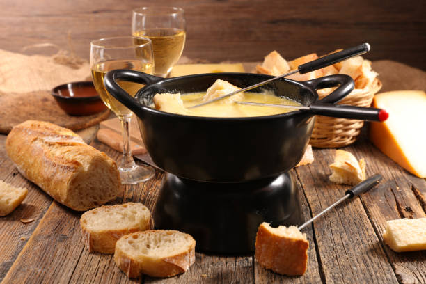istock cheese fondue with bread and wine glasses 1334982599