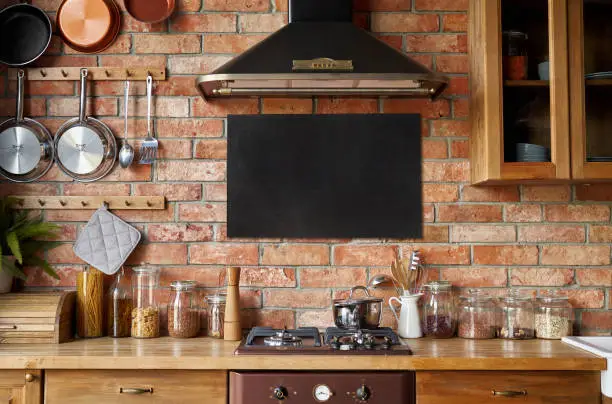 Mock up of chalkboard in kitchen interior. Panoramic background with kitchen utensils.