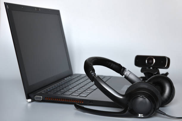 istock Notebook with headphones with mic and a webcam, concept of smart working or online communications. 1334985595
