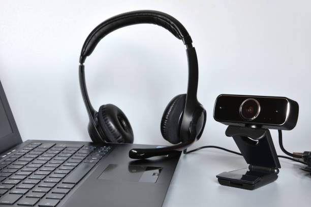 istock Notebook with headphones with mic and a webcam, concept of smart working or online communications. 1334985597