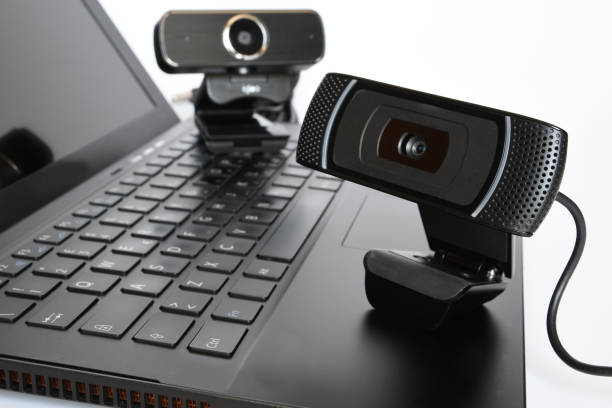 Black computer webcam on notebook keyboard. stock photo