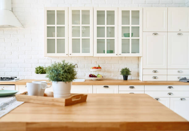 istock Kitchen wooden table top and kitchen blur background interior style scandinavian 1334986508
