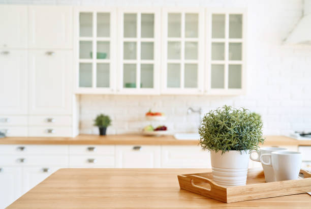 istock Kitchen wooden table top and kitchen blur background interior style scandinavian 1334986778