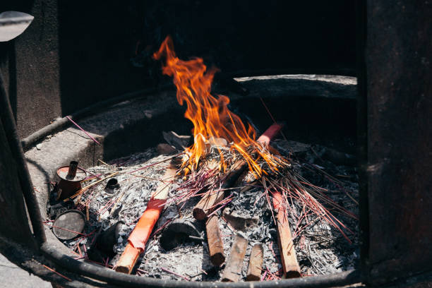 Scented sticks are burned in a special stump, a religious ritual stock photo