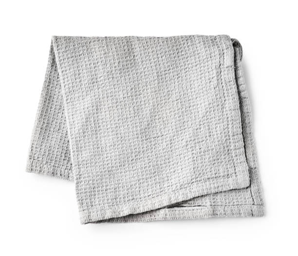istock Kitchen grey folded table cloth isolated on white background. Top view of napkin. 1334987575