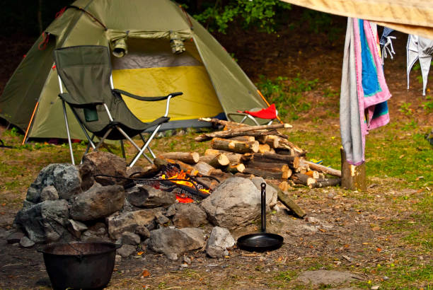 istock Empty armchairs for relaxing on a campfire background. Beach chairs around the fire. Night vacation in nature. 1334991060