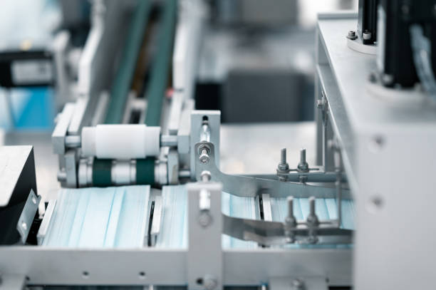 istock Scientists wearing protective clothing Inspect mask making machines in a laboratory at an industrial plant. Anti-virus production warehouse. concept of safety and prevention coronavirus covid-19. 1334991095