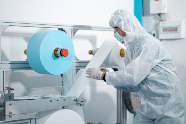 istock Scientists wearing uniform protection. Check the manufacturing process of face masks. In a laboratory at industry plants. The concept for security and protection coronavirus covid-19. 1334991099