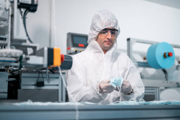 istock Scientists wearing uniform protection. Check the manufacturing process of face masks. In a laboratory at industry plants. The concept for security and protection coronavirus covid-19. 1334991254