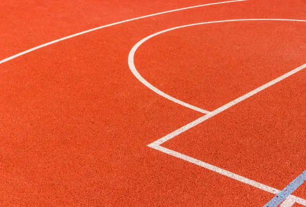Basketball court lines. Brown field rubber ground with white lines.