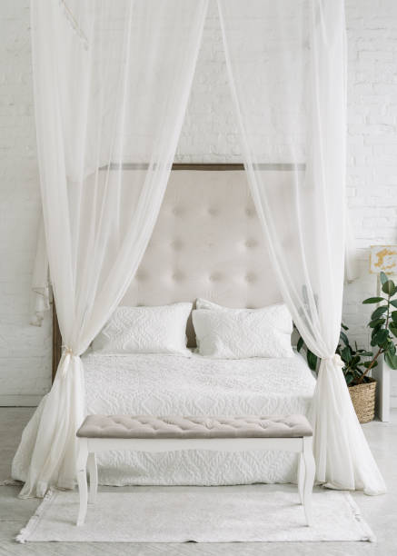 istock White bedroom interior, closeup at canopy bed. 1334993322
