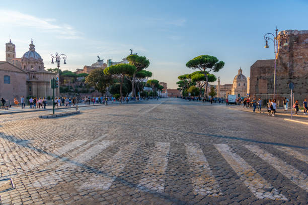 Tourists in Via dei Fori Imperiali at dusk