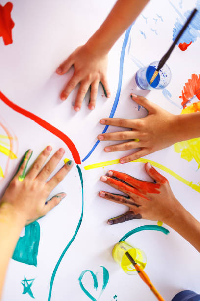 istock Group of children having fun whit colors 1334994331
