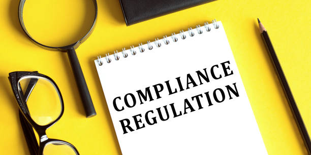 istock Lettering on the yellow office table - Compliance regulation 1334994376