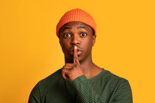 istock Keep Silence. Portrait Of Young Black Guy Showing Shh Gesture At Camera 1334994713