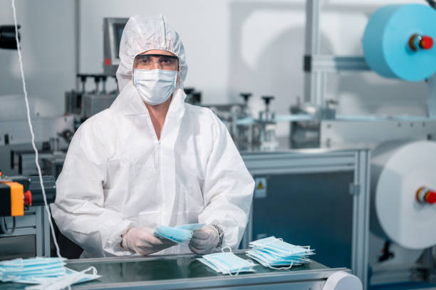 istock Scientists wearing uniform protection. Check the manufacturing process of face masks. In a laboratory at industry plants. The concept for security and protection coronavirus covid-19. 1334995265