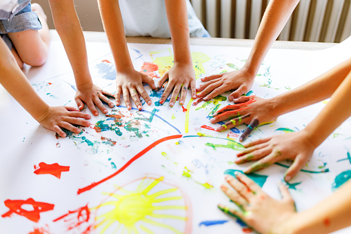 Close-up of children's hands playing whit colors