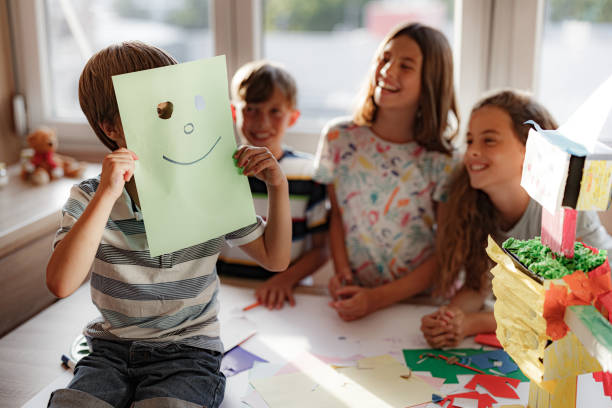 istock Child holding a smile face drawing. Happy emotion. 1334999019