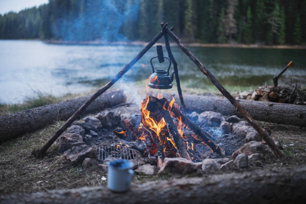 istock Campfire with a vintage teapot next to the lake 1334999078