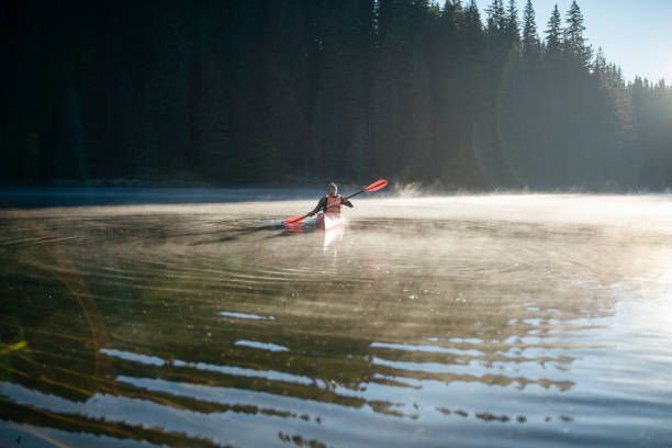istock Senior man kayaking on still lake 1334999079