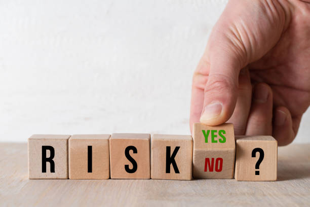 hand turning the cube with the answers YES and NO to the message RISK? stock photo