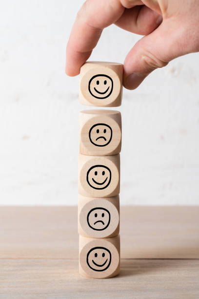 istock hand stacking cubes with smiley symbols 1334999886