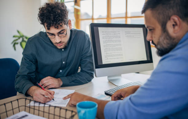 Man on job interview Two people, young man on a job interview in modern office. Male manager is interviewing him. Resume stock pictures, royalty-free photos & images