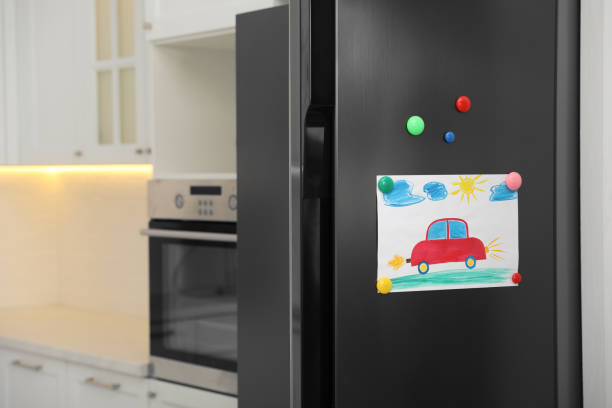 modern refrigerator with child's drawing and magnets in kitchen - domestic car color image horizontal car imagens e fotografias de stock