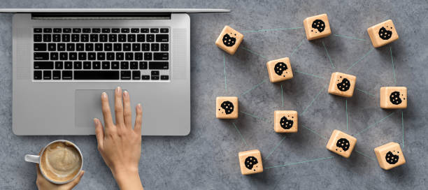 Dice with Cookie icons and a laptop conceptual of the GDPR regulations stock photo