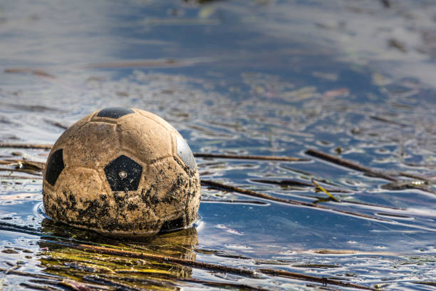 Old Soccer ball on blue color concrete floor