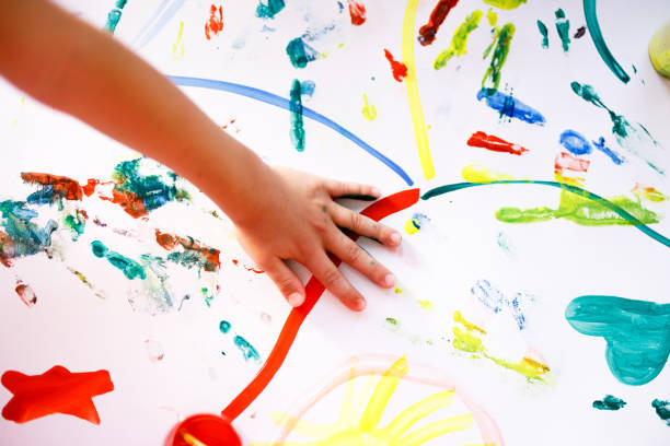 istock Unrecognizable chlid playing whit watercolors 1335001106