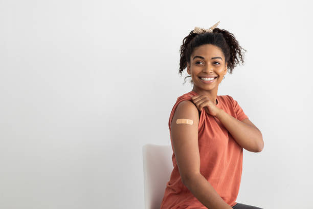istock Beautiful black woman got vaccinated, looking at copy space 1335002481