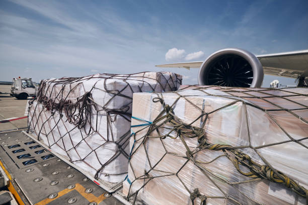 istock Cargo containers against jet engine of freight airplane