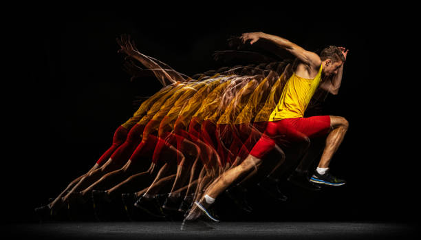 Portrait of young man, professional male athlete, runner in motion and action isolated on dark background. Stroboscope effect. Evolution of movements. Portrait of young man, professional male athlete, runner in action isolated on dark background. Stroboscope effect. Concept of healthy lifestyle, sport, achievemnts, goal, ad. temporal aliasing stock pictures, royalty-free photos & images