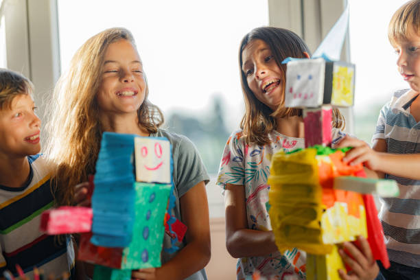 istock Group of kids making robot toys from cardboard 1335005884
