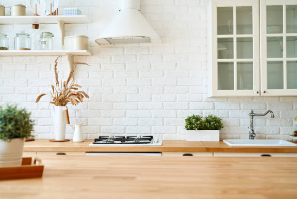 istock Kitchen wooden table top and kitchen blur background interior style scandinavian 1335007278