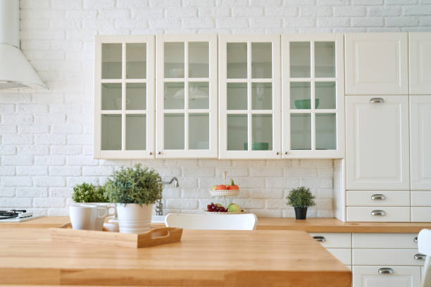 istock Kitchen wooden table top and kitchen blur background interior style scandinavian 1335007398