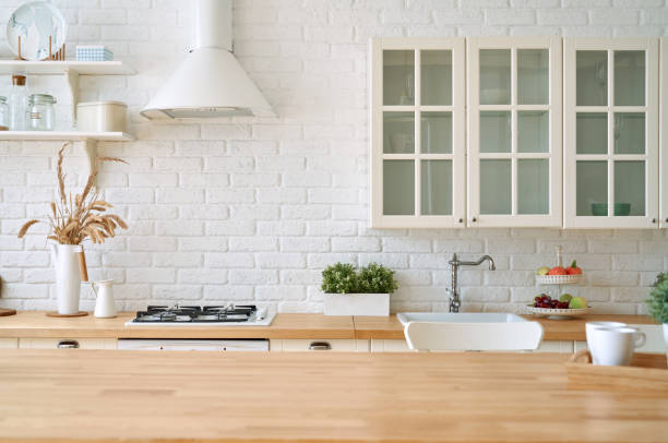 istock Kitchen wooden table top and kitchen blur background interior style scandinavian 1335008486