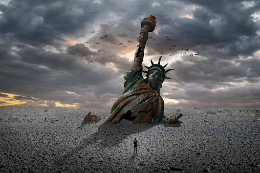 Statue of Liberty half buried in the sand